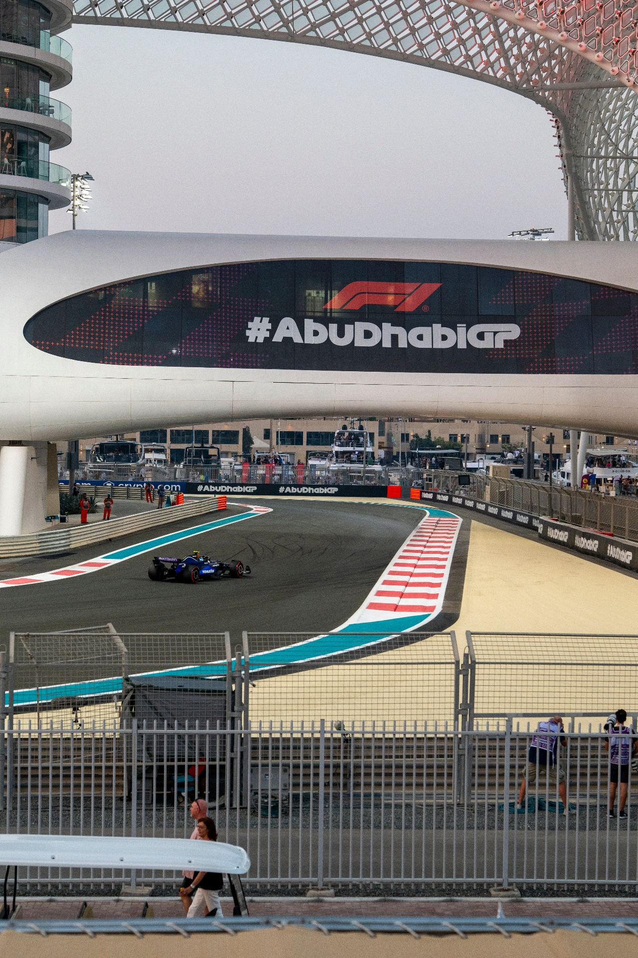 Formula One car racing beneath the Abu Dhabi Grand Prix bridge at Yas Marina