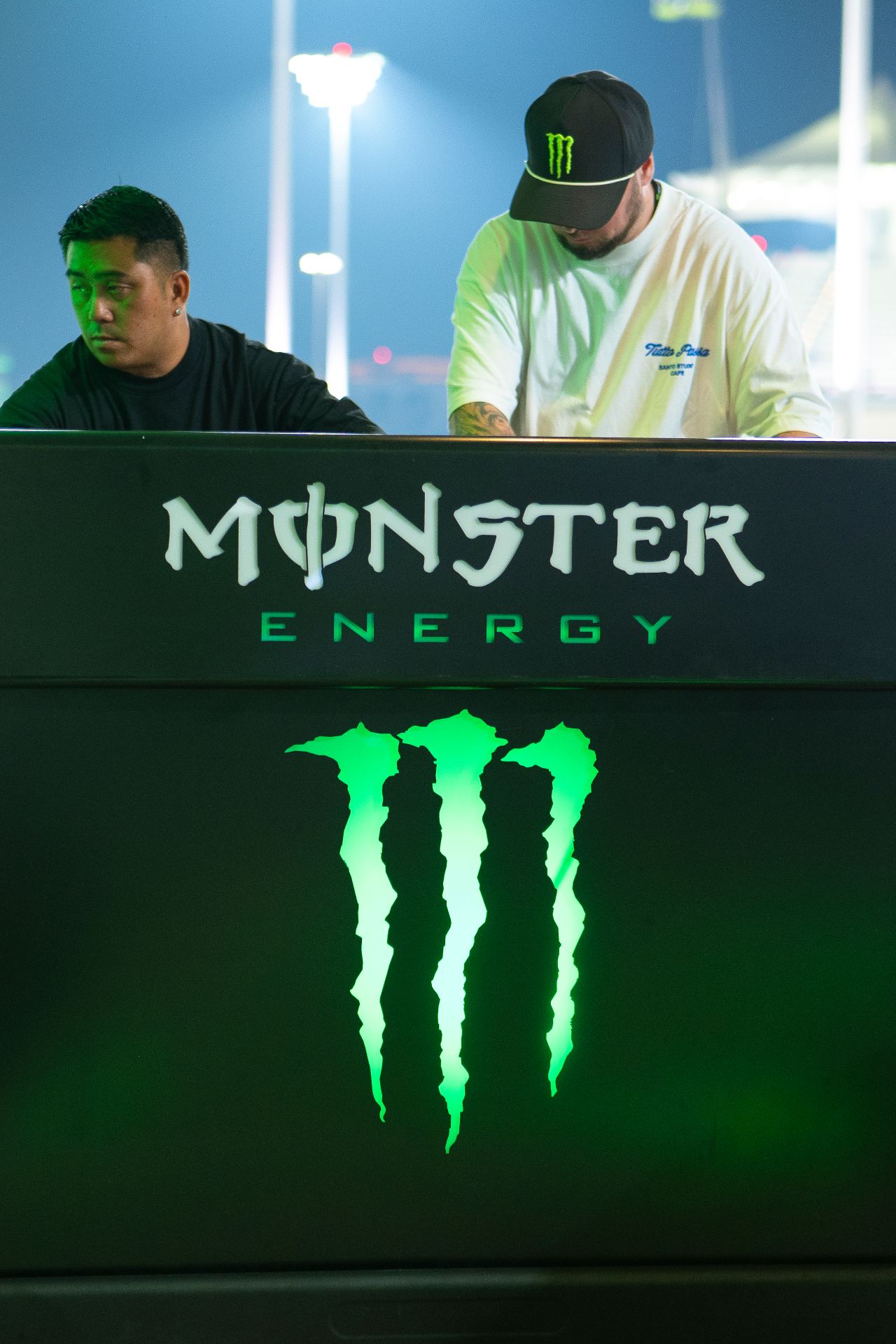 DJ booth branded with Monster Energy during an evening hospitality set