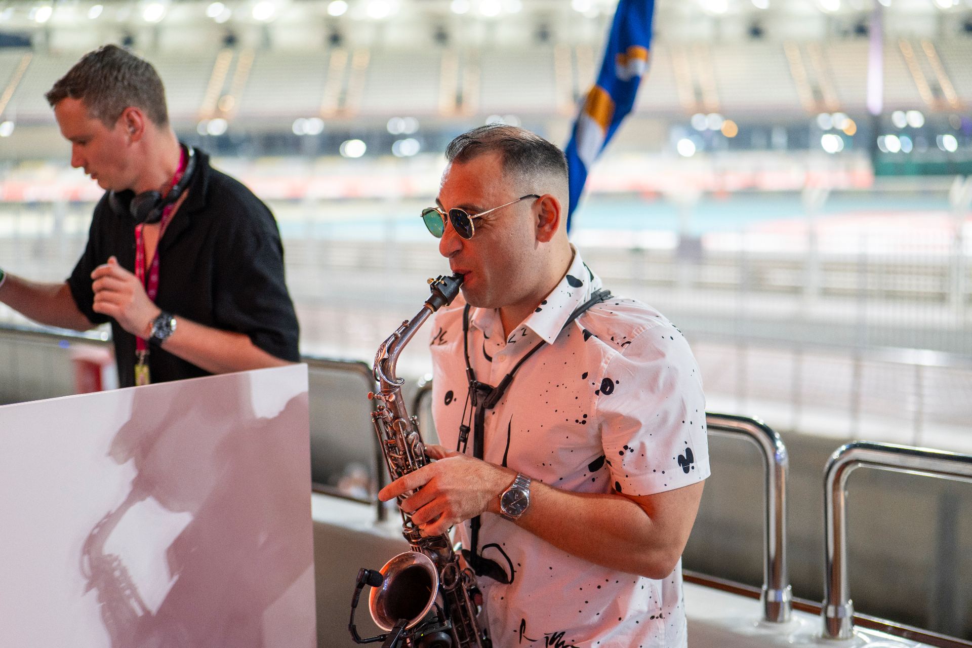 Live saxophonist performing in the hospitality suite overlooking the circuit