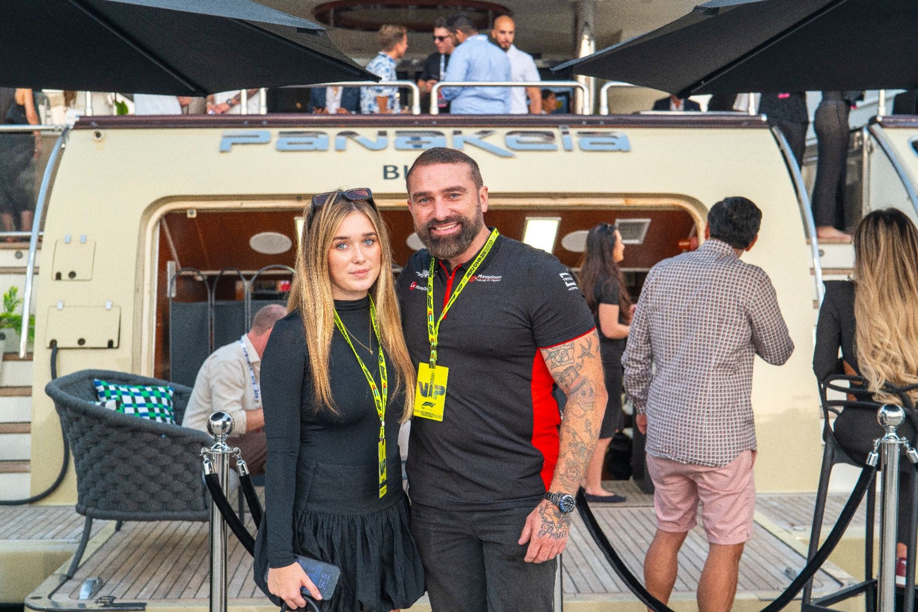 VIP guests posing together in front of the hospitality yacht